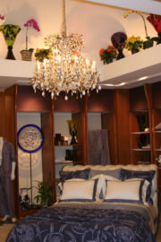 The bed, chandelier and shelves at Barbara Lazaroff's Frette display