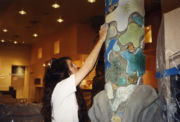 Barbara Lazaroff placing tiles onto a Granita restaurant pillar Barbara Lazaroff placing tiles onto a Granita restaurant pillar